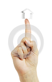 Small house from a paper in a hand