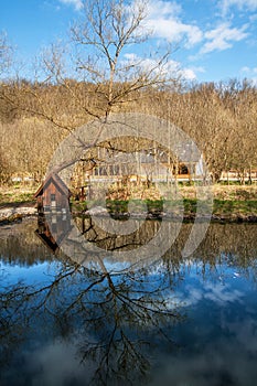 Small house on a pond with reflections