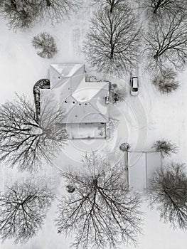 Small House Snowed in During Winter from an Overhead Aerial View