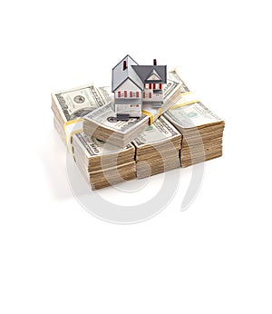Small House on Stacks of Hundred Dollar Bills Isolated on a White Background