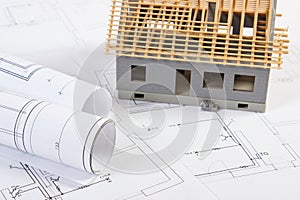 Small house under construction and electrical drawings, concept of building home