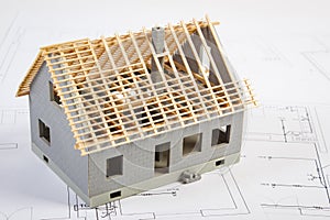 Small house under construction on electrical drawings, concept of building home