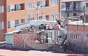 Small houses in the city with a lot of trash on the rooftop