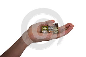 Small houses on the female hand. Isolated on white background. Symbol of buying a house, insurance, construction, property