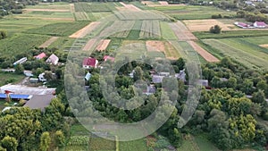 Small houses. Green fields. Aerial view of the village