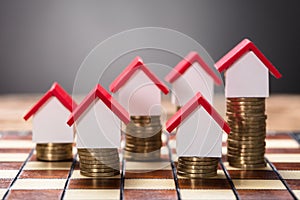 Small Houses On Stacked Coins