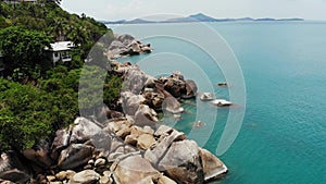 Small houses on tropical island. Tiny cozy bungalows located on shore of Koh Samui Island near calm sea on sunny day in Thailand.