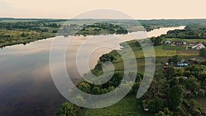 Small houses at Ukrainian village at summer sunny day 4k aerial view river