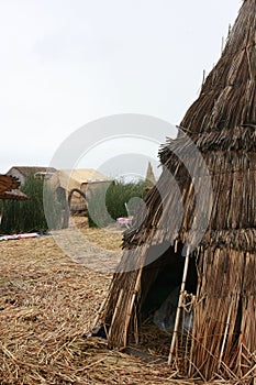 A small hut made of reeds with a opening to enter on the man made island in Lake Titicaca, Peru