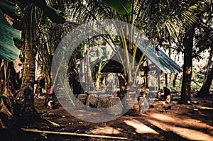 Small hut in a tropical forest with wooden cages for the lifestock. Local village on Nusa Penida, Bali