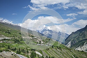 Small illage and green fields in mountains