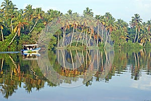 Small indian boat floats on the tropical river
