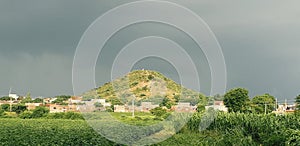 Small indian village in summer with green grass and farm