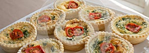 Small Individual Quiche Topped with Tomato and Parsley.