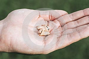 Small intra channel hearing aid device in a man`s hand.