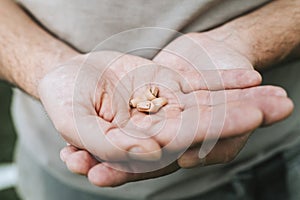Small intra channel hearing aid device in a man`s hands.