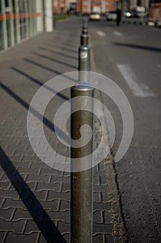 Small iron posts along the road