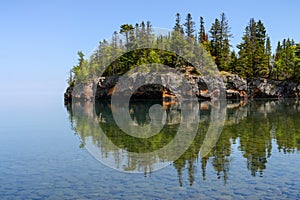 Small island on the Minnesota North Shore reflecting in lake
