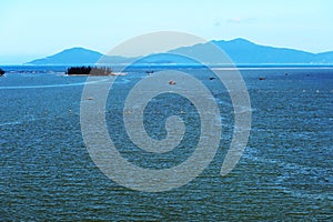 Small island at the mouth of the Thu Bon river in Hoi An, Vietnam with Cu Lao Cham island in the background