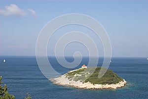 Small island in scenic ocean