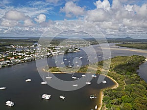 the small island with several white boats docked in it next to a sandy beach