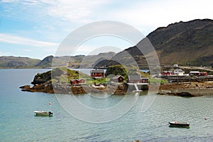 Small island with tiny fishing village in the middle of fjord. Mageroya.