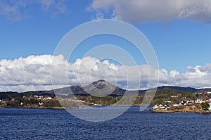 Small Islands within the Bergen Fjord with Traditional Norwegian Houses situated on them.