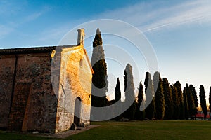 Small italian town church at sunset in outdoor park in turistic spot in autumn evening