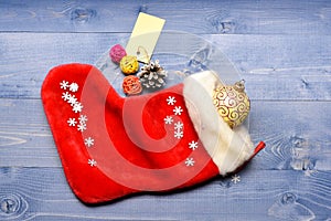 Small items stocking stuffers or fillers little christmas gifts. Christmas sock toned wood background top view. Fill