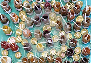 Small jars with jams for tasting on a market place