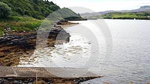 A small jetty on the shores of a lake or loch on the Isle of Skye, Scotland, UK on a cloudy day