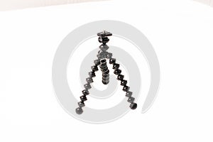 A small Joby Gorillapod tripod on a white table