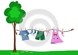 Small kid clothes drying on a rope photo