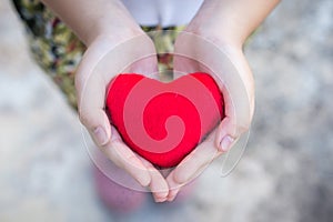 Small kid hands holding heart