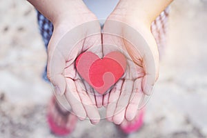 Small kid hands holding heart