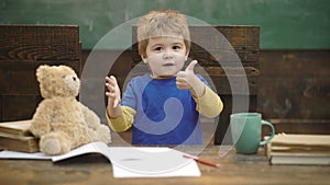 Small kid learning to count. Adding numbers with hands. Math lesson at kindergarten. School children, counting on