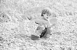 Small kid planting a flower. earth day. soils and fertilizers. summer farm. happy child gardener. Flowers presentation