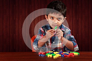 A small kid playing with alphabets