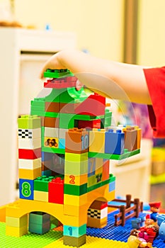 Small kid playing with constructor at home