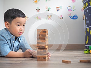 Small kid playing with wooden blocks