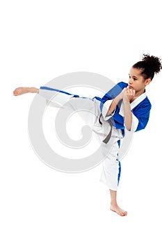 Small kid practicing karate kick