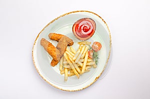 Small kid`s meal. A plate of chicken nuggets with french fries with ketchup on a white background. Top view children`s menu food