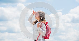 Small kid on sunny sky background. summer and spring season. holiday and vacation. happy childhood. smiling student with