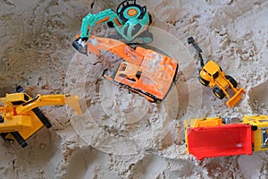 Small kid toy vehicle construction in sand playground