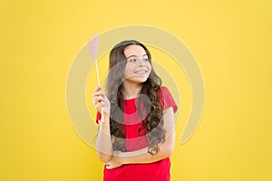 Small kid yellow background. cheerful child with beautiful long hair. little beauty. birthday party time. smiling little