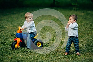 Small kids brothers driving bicycle