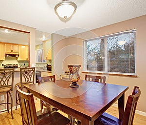 Small kitchen and dining rom with square table.