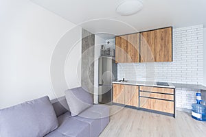 Small kitchenette in a studio, interior lighting.