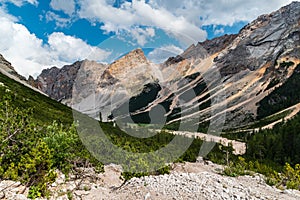 Small Lago Piciadel lake with peaks above in the Dolomites - view from Alta Via hiking trail photo