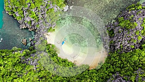 Small lagoon with sandy beach, view from above. Caramoan Islands, Philippines.